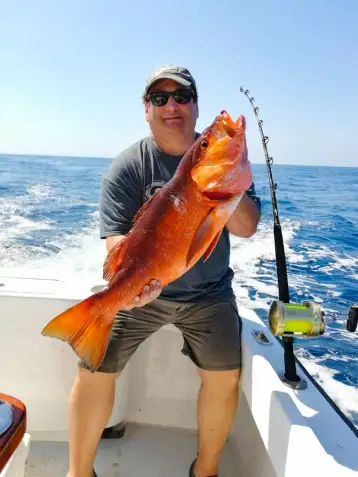 man with snapper los suenos costa rica fishing