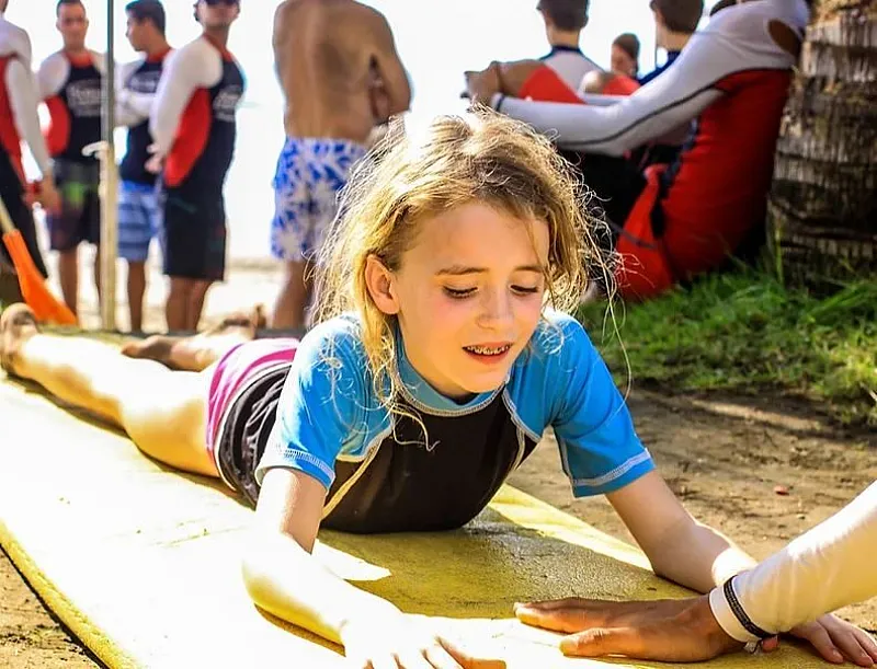 child learning to surf jaco beach costa rica